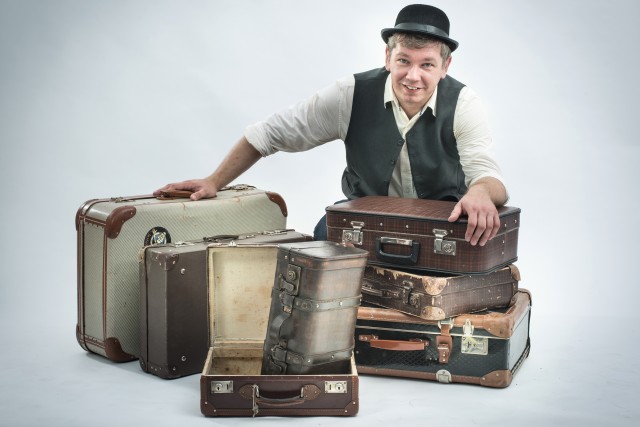 Mężczyzna z kapeluszem, staromodne walizki